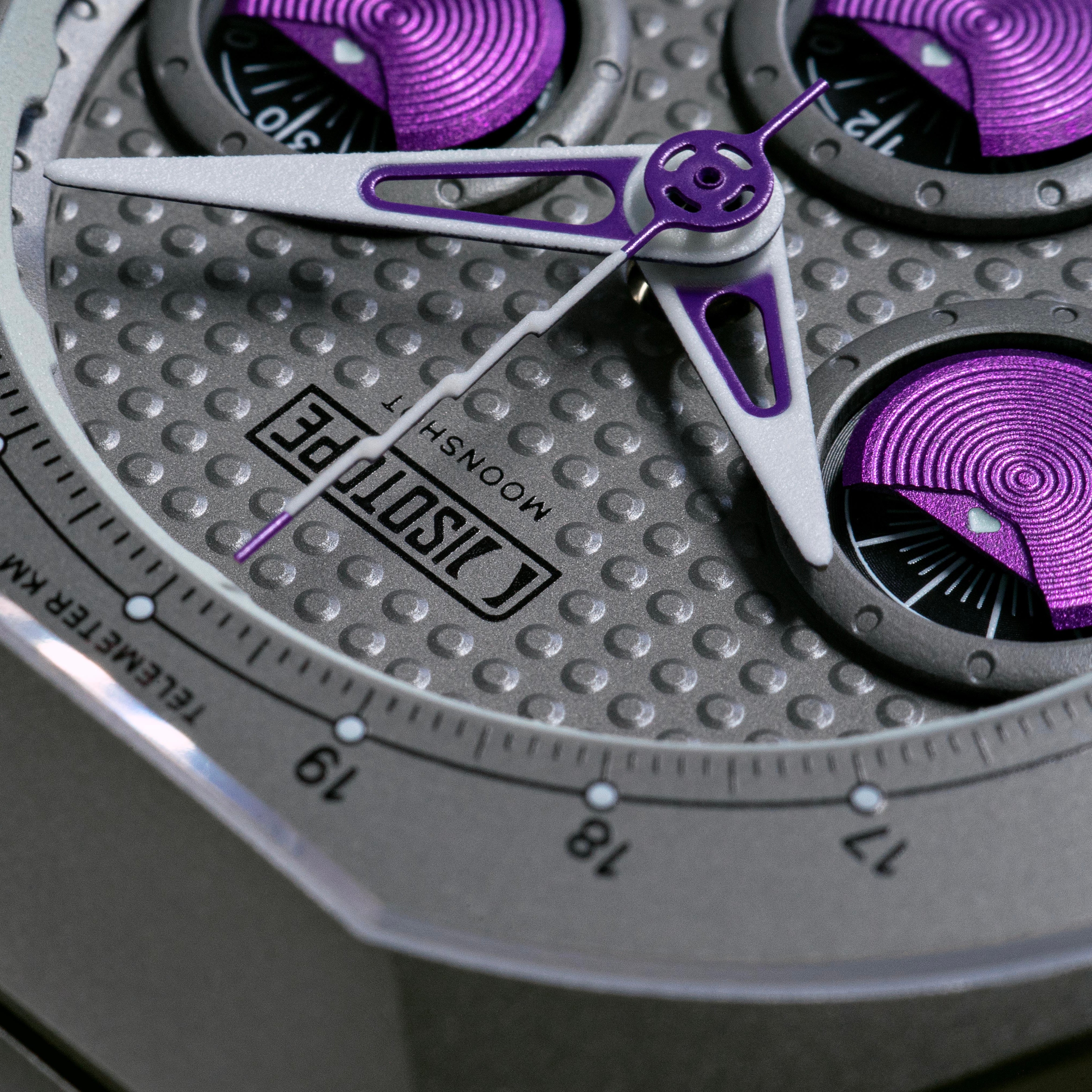 Isotope Moonshot Chronograph Thunderclap Close-up purple and silver accents on a gray textured background