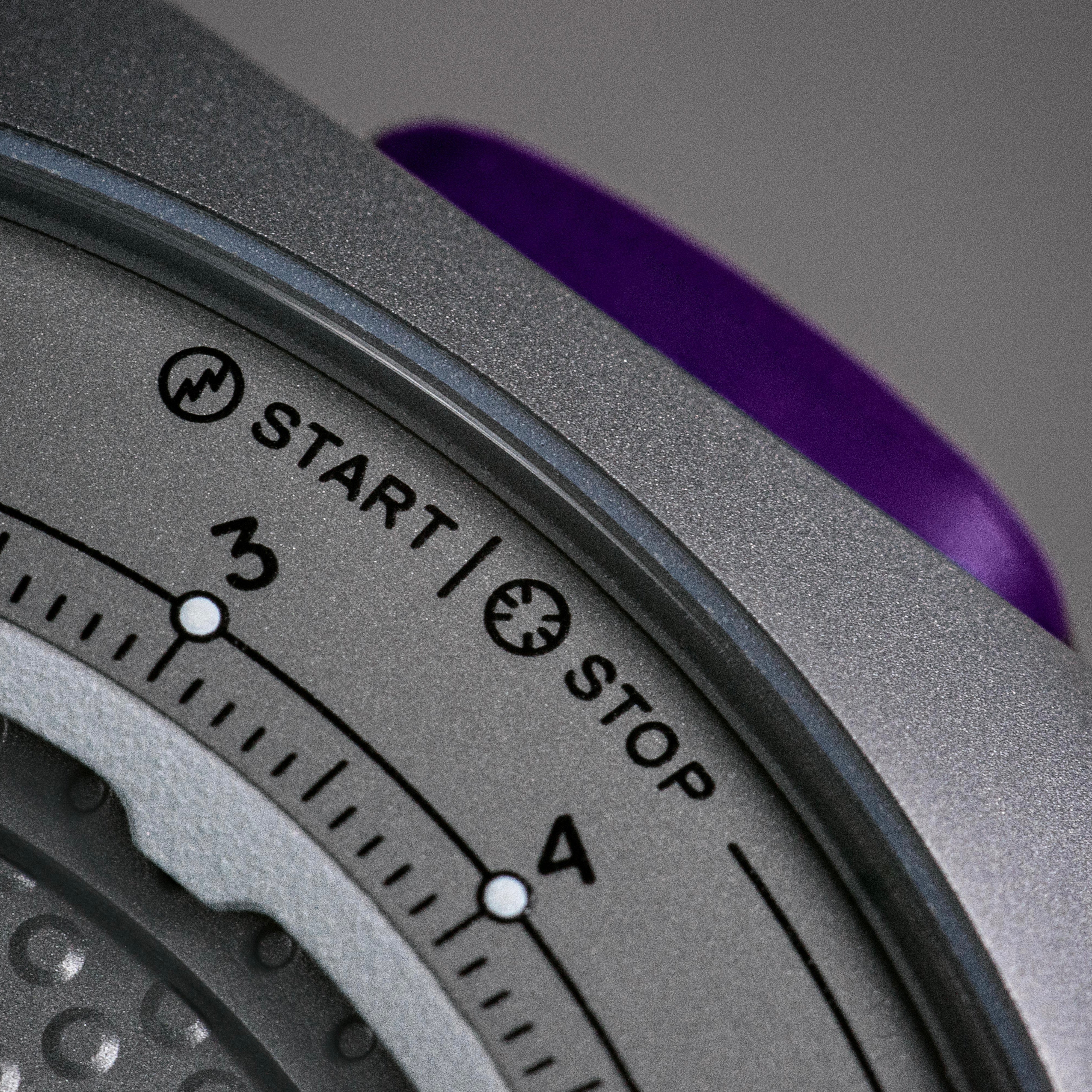 Isotope Moonshot Chronograph Thunderclap Close-up of a purple push button and grey telemeter bezel