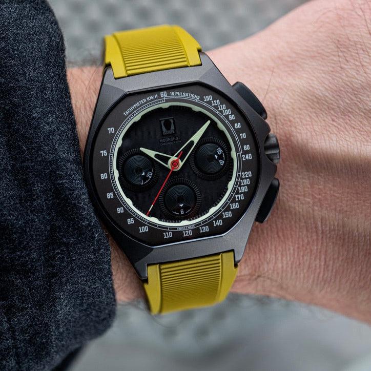Close-up of a person wearing a Moonshot Stealth with a mustard yellow strap
